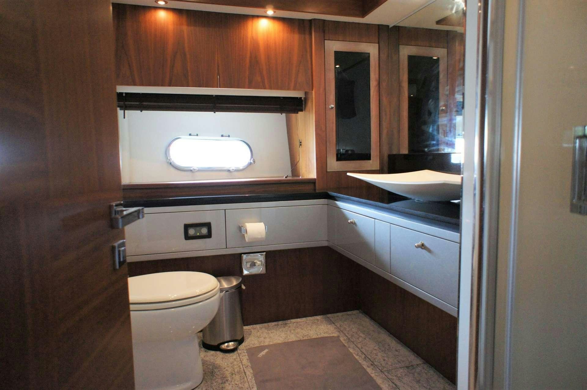a bathroom with a sink and toilet aboard SYDNEY Yacht for Charter