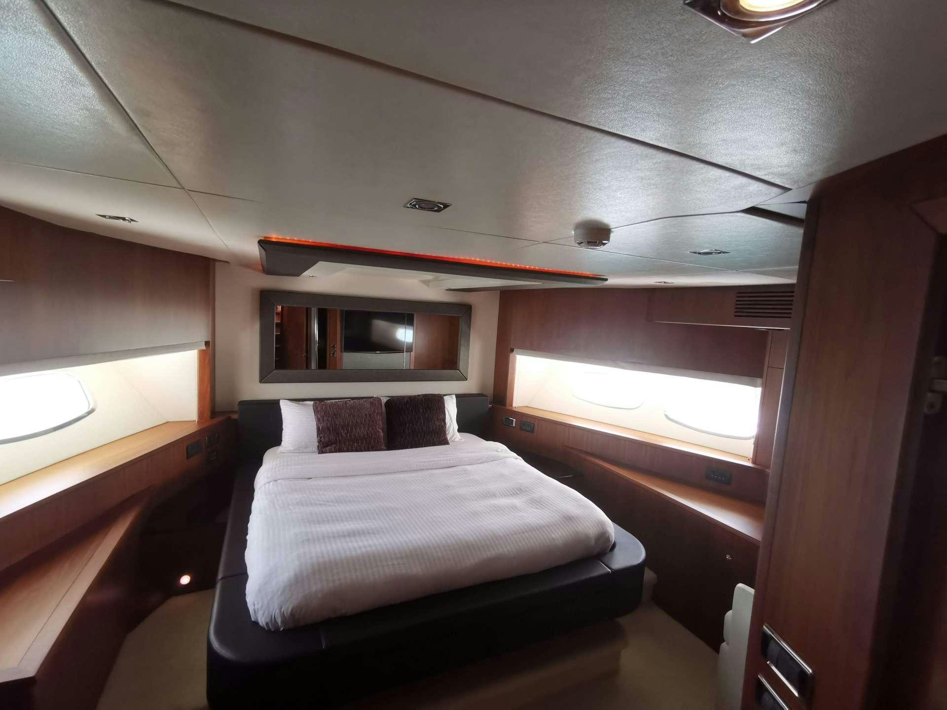 a room with a bed and a window aboard SYDNEY Yacht for Charter