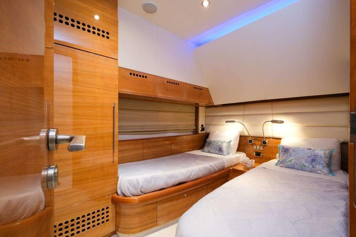a room with a bed and a closet aboard NOE Yacht for Charter
