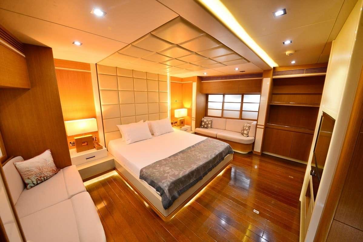 a large room with a bed and a large mirror aboard ZELDA Yacht for Charter