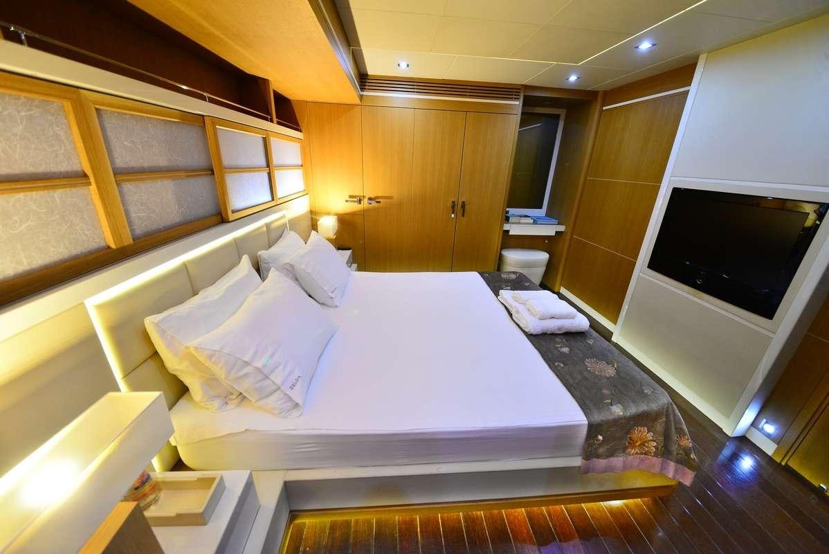 a room with a bed and a tv aboard ZELDA Yacht for Charter