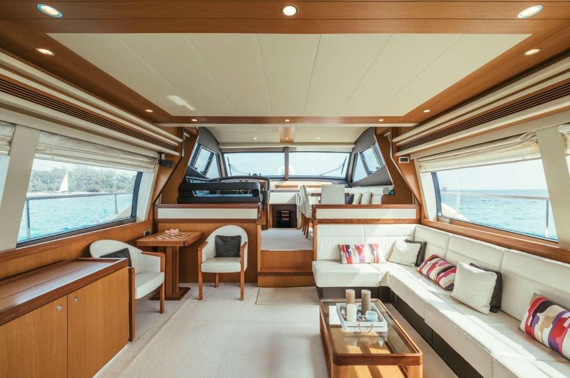 a room with a couch and a table and a bed aboard TO ESCAPE Yacht for Charter