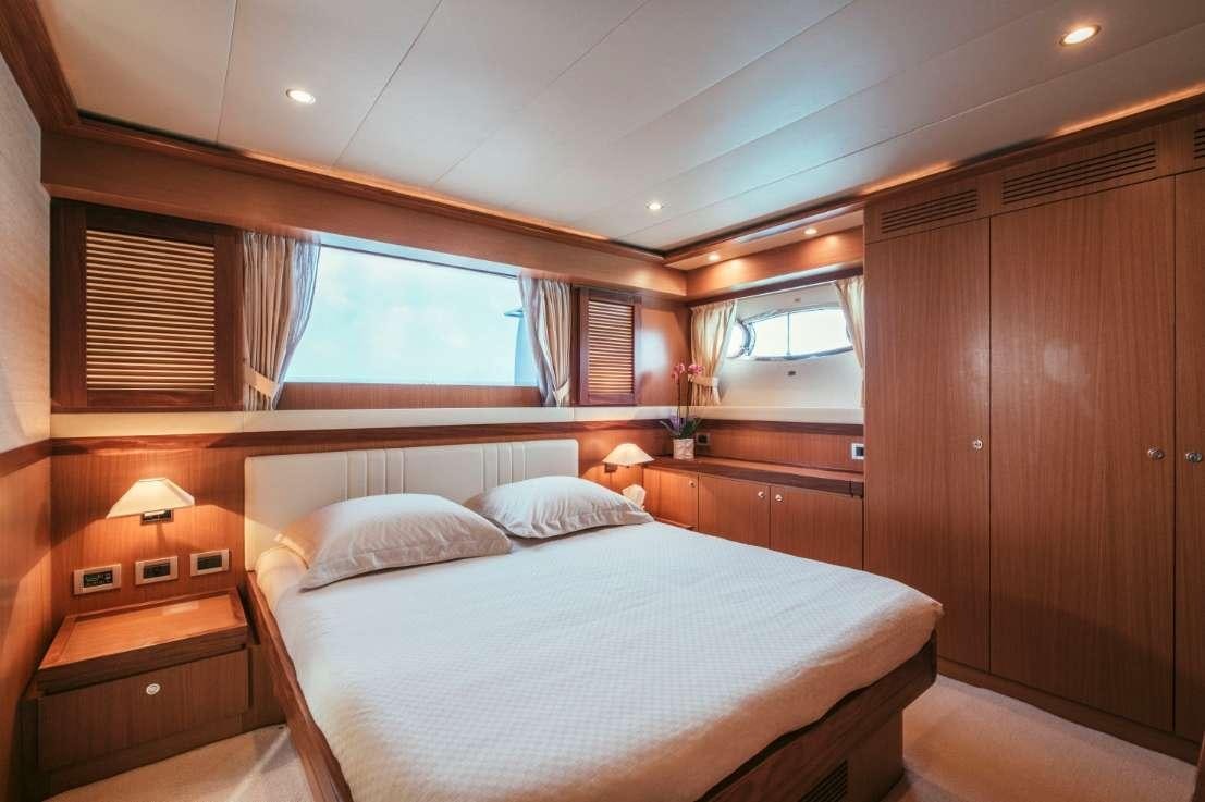 a room with a bed and a window aboard TO ESCAPE Yacht for Charter