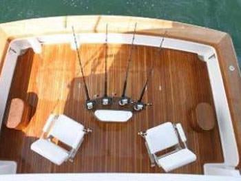 a wooden table with a white tablecloth and chairs aboard PRIORITY Yacht for Charter