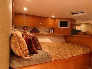 a room with a couch and a television aboard PRIORITY Yacht for Charter