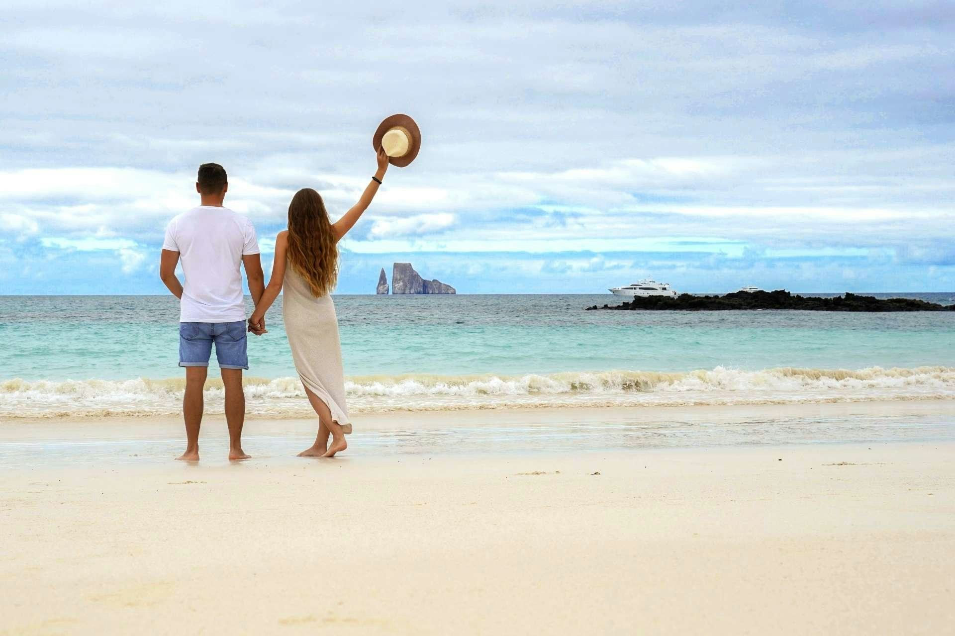 a man and woman playing with a ball on a beach aboard GRAND MAJESTIC Yacht for Charter