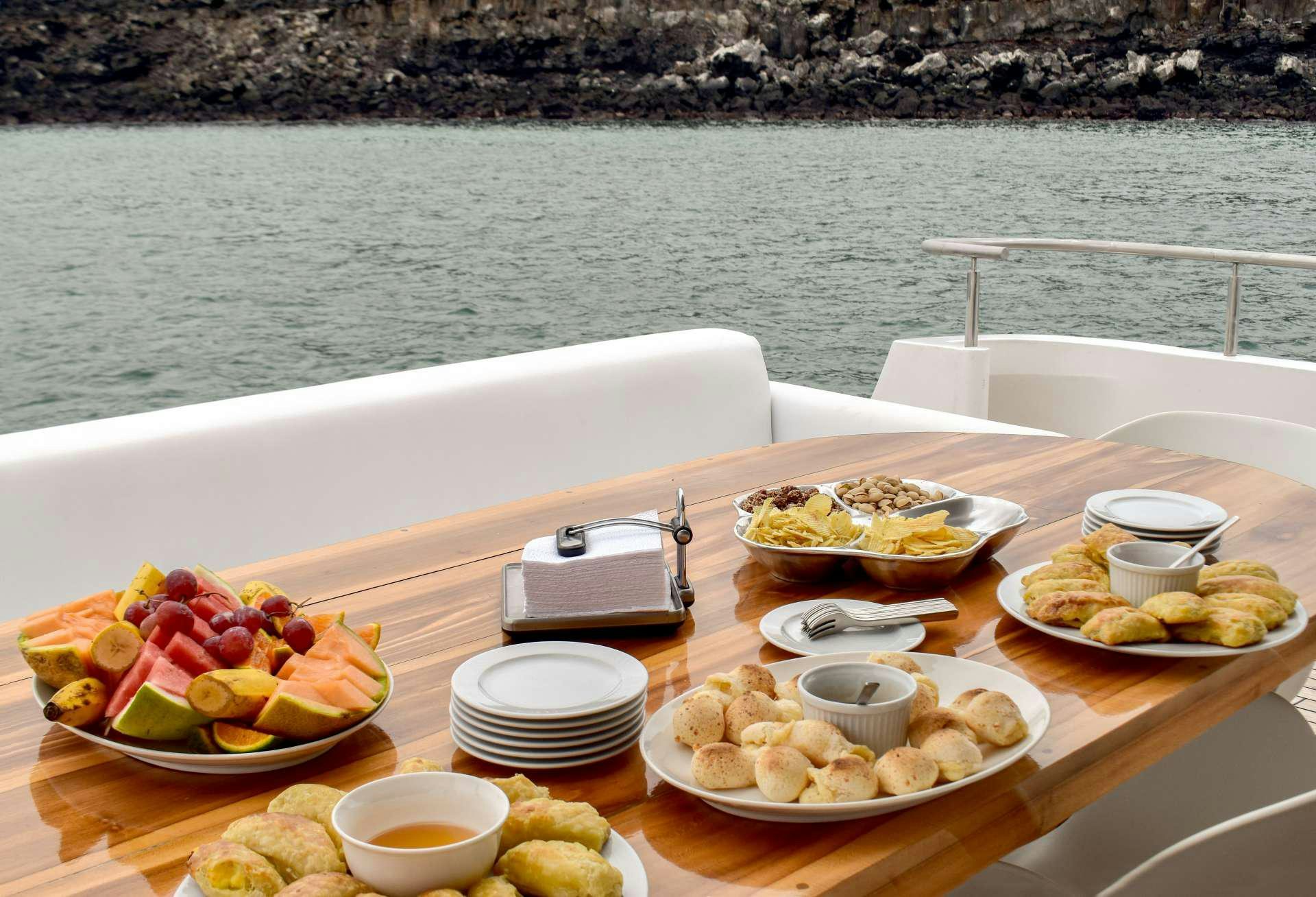 a table with food on it aboard GRAND MAJESTIC Yacht for Charter