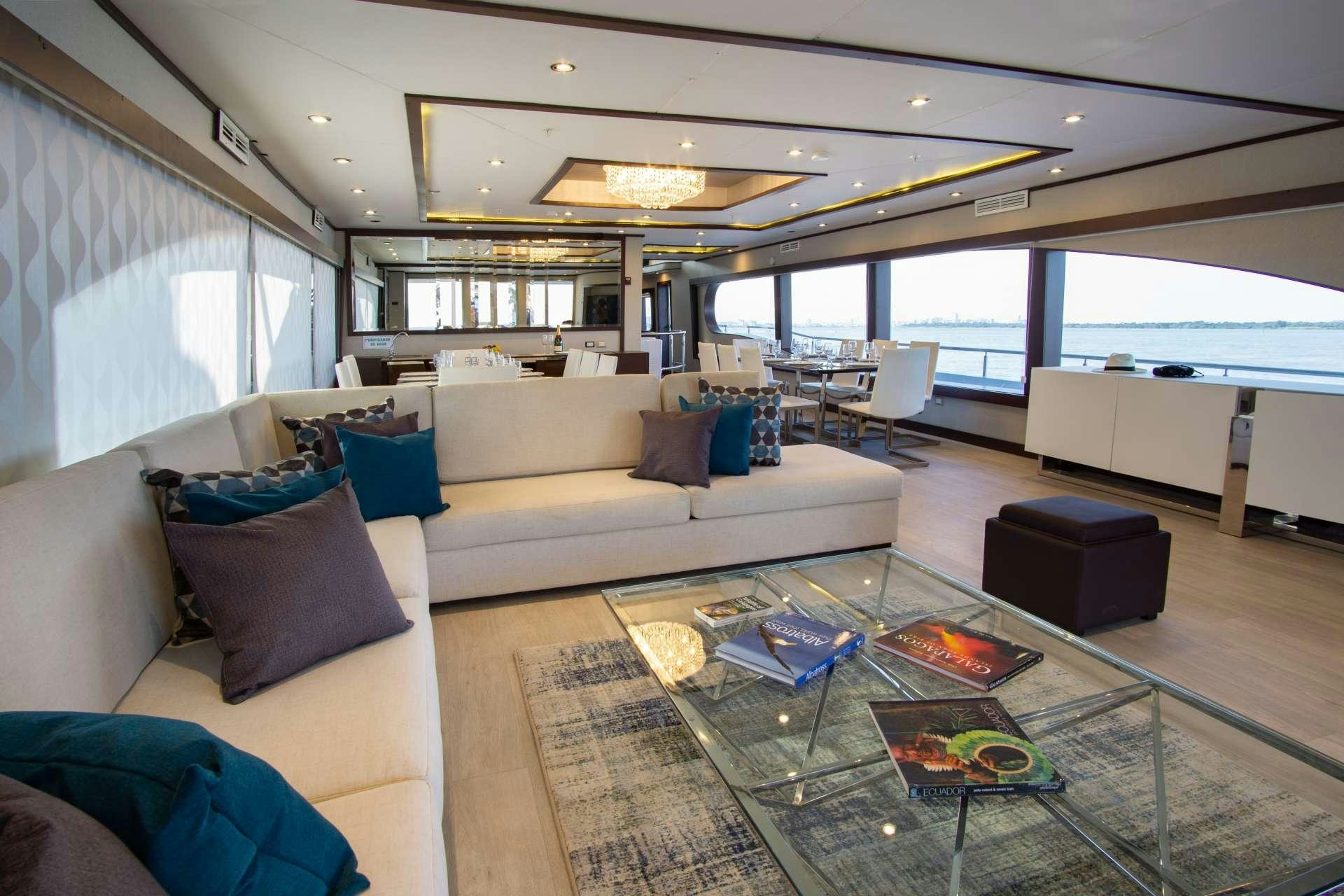a living room with a large window aboard GRAND MAJESTIC Yacht for Charter