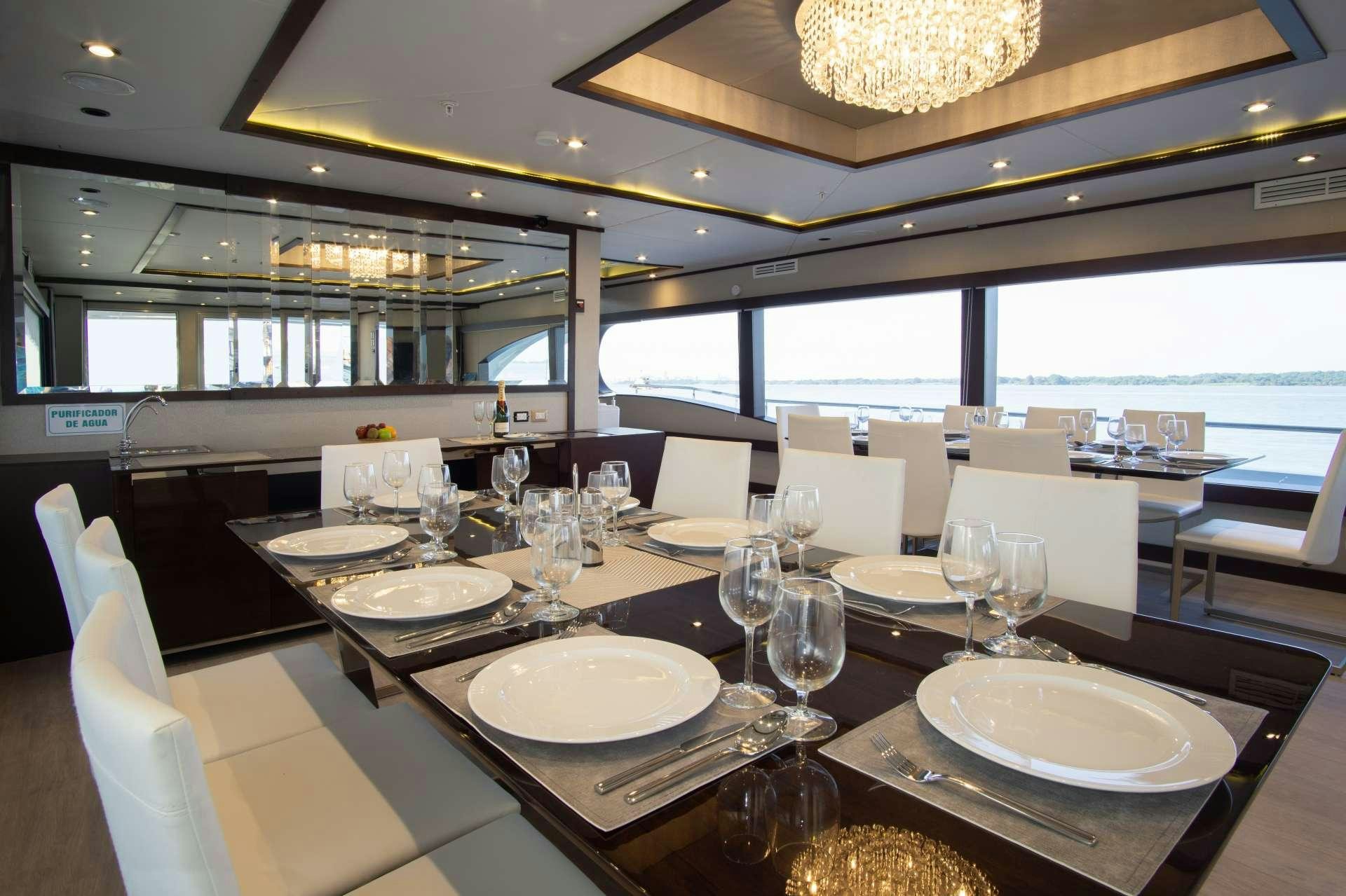 a table set for a dinner aboard GRAND MAJESTIC Yacht for Charter
