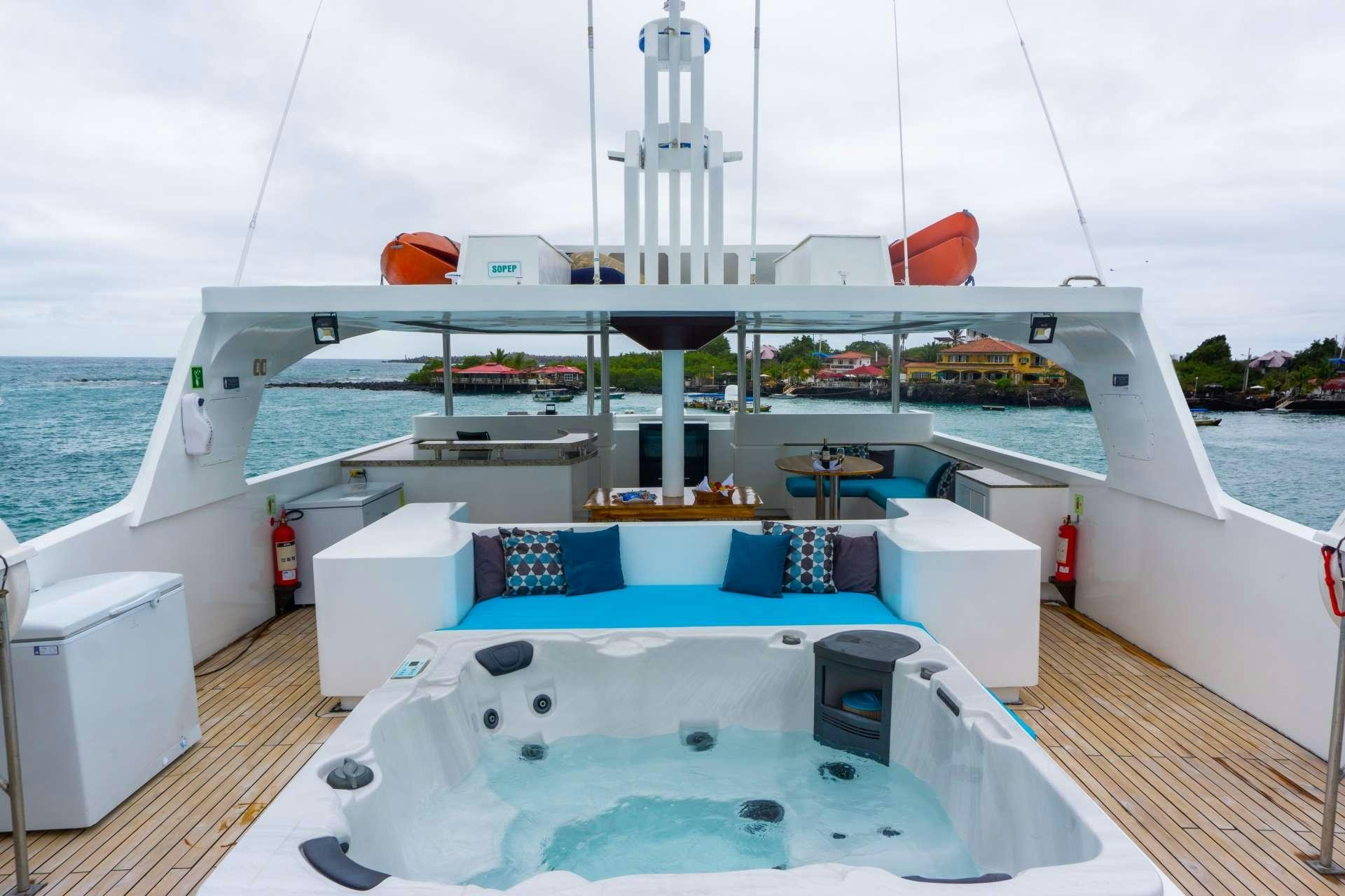 a large cruise ship with a large cruise ship in the background aboard GRAND MAJESTIC Yacht for Charter