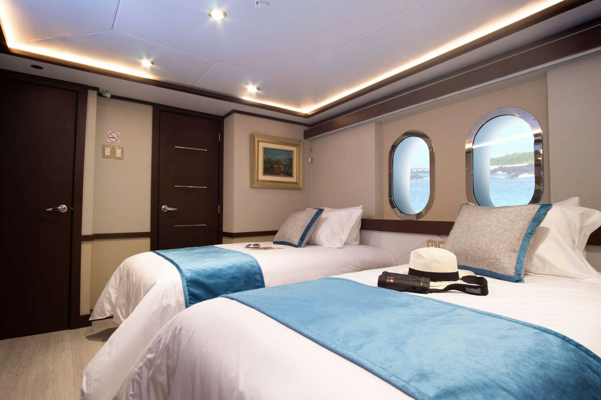 a couple of beds in a room aboard GRAND MAJESTIC Yacht for Charter