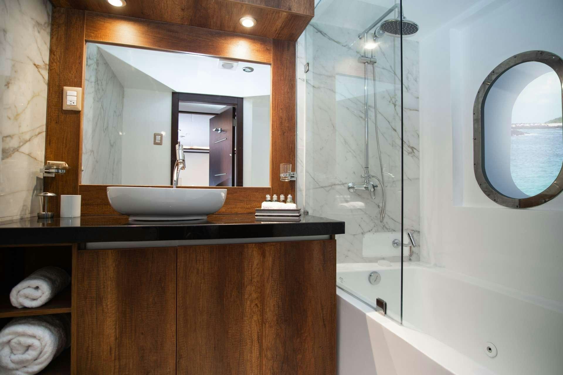 a bathroom with a large mirror aboard GRAND MAJESTIC Yacht for Charter