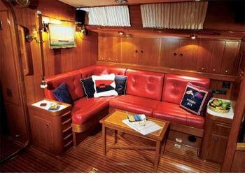 a living room with a red couch aboard MELINKA Yacht for Charter