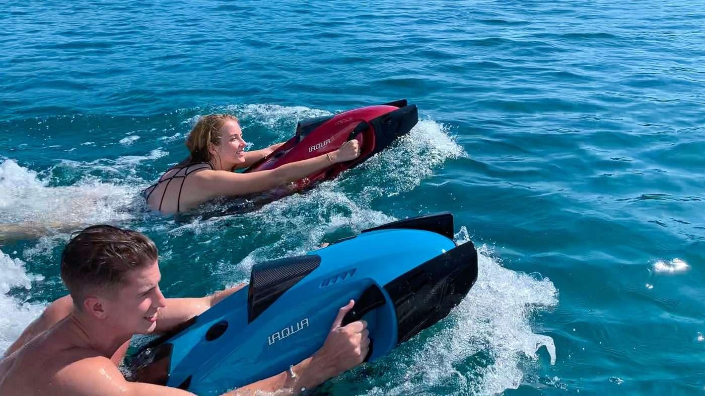 a person and a boy riding a surfboard in the ocean aboard BLUE HORIZON Yacht for Charter