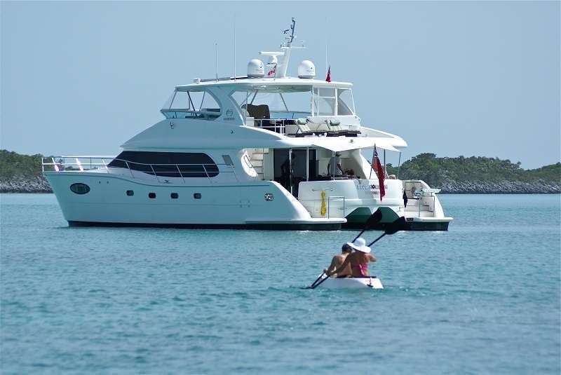a large white boat with a person in it aboard BLUE HORIZON Yacht for Charter