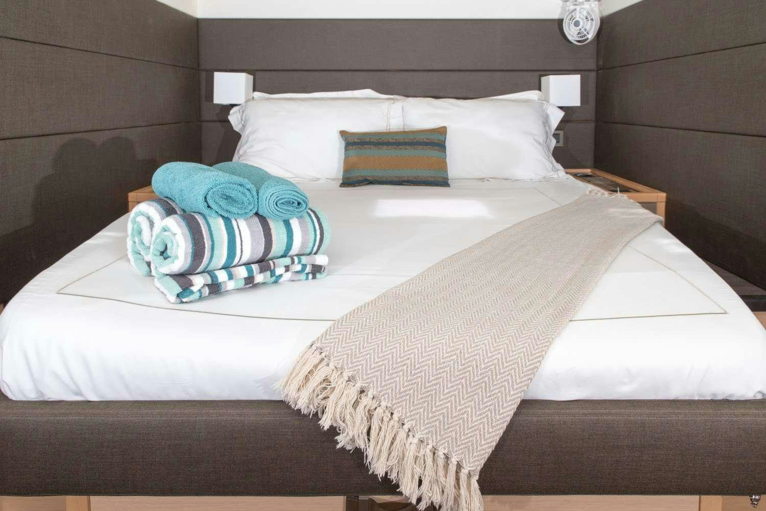 a couple of beds in a hotel room aboard MELARNIE Yacht for Charter