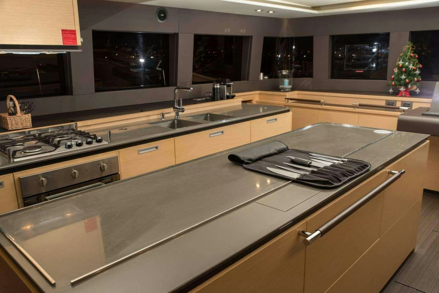 a kitchen with a stove and a sink aboard MELARNIE Yacht for Charter