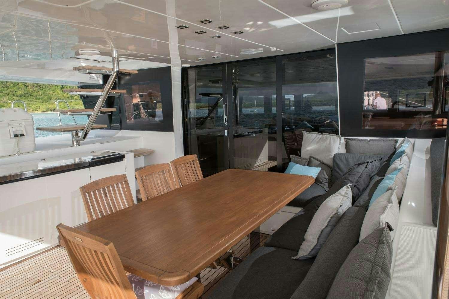a room with a table and chairs aboard MELARNIE Yacht for Charter