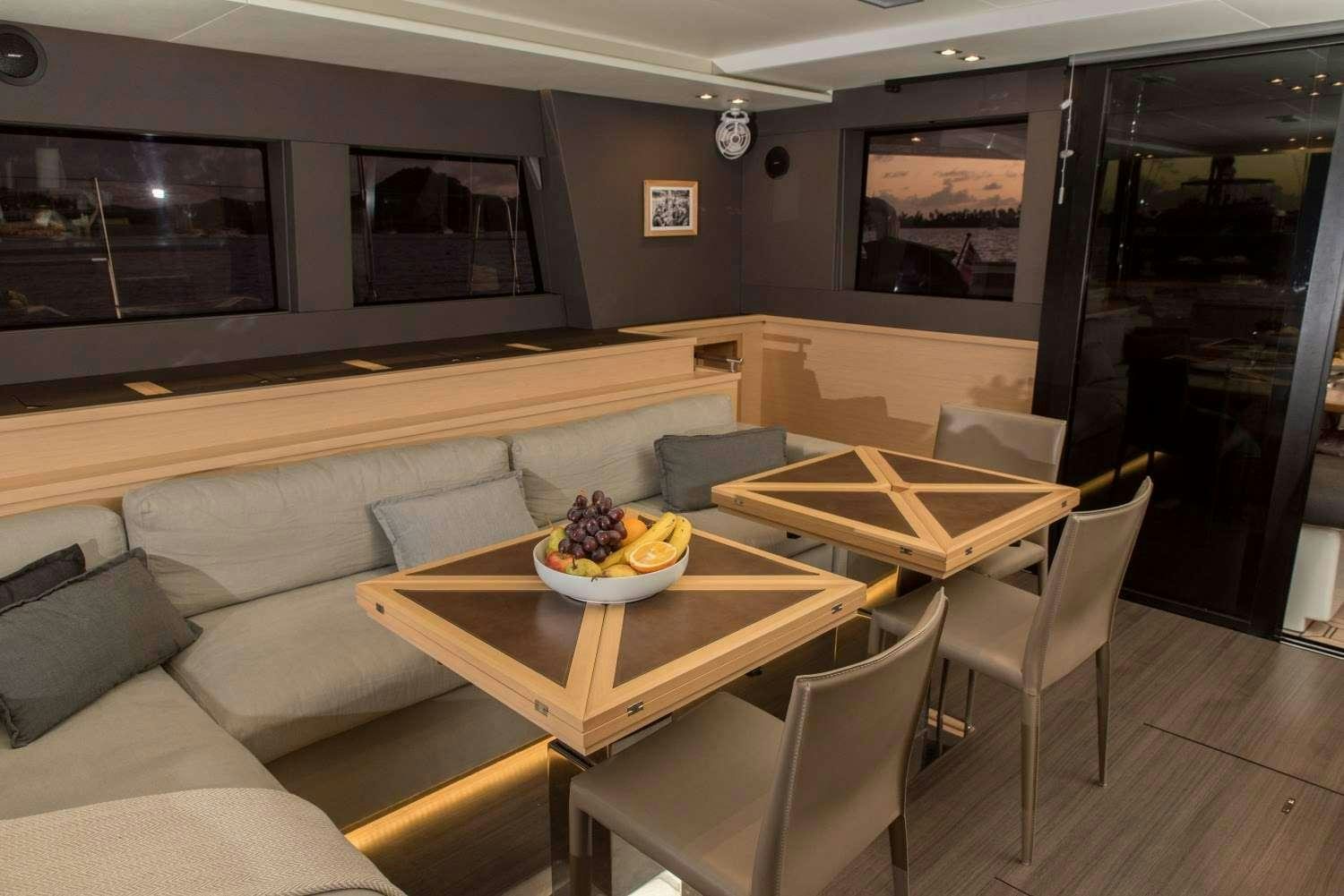 a room with a couch and a table and chairs aboard MELARNIE Yacht for Charter