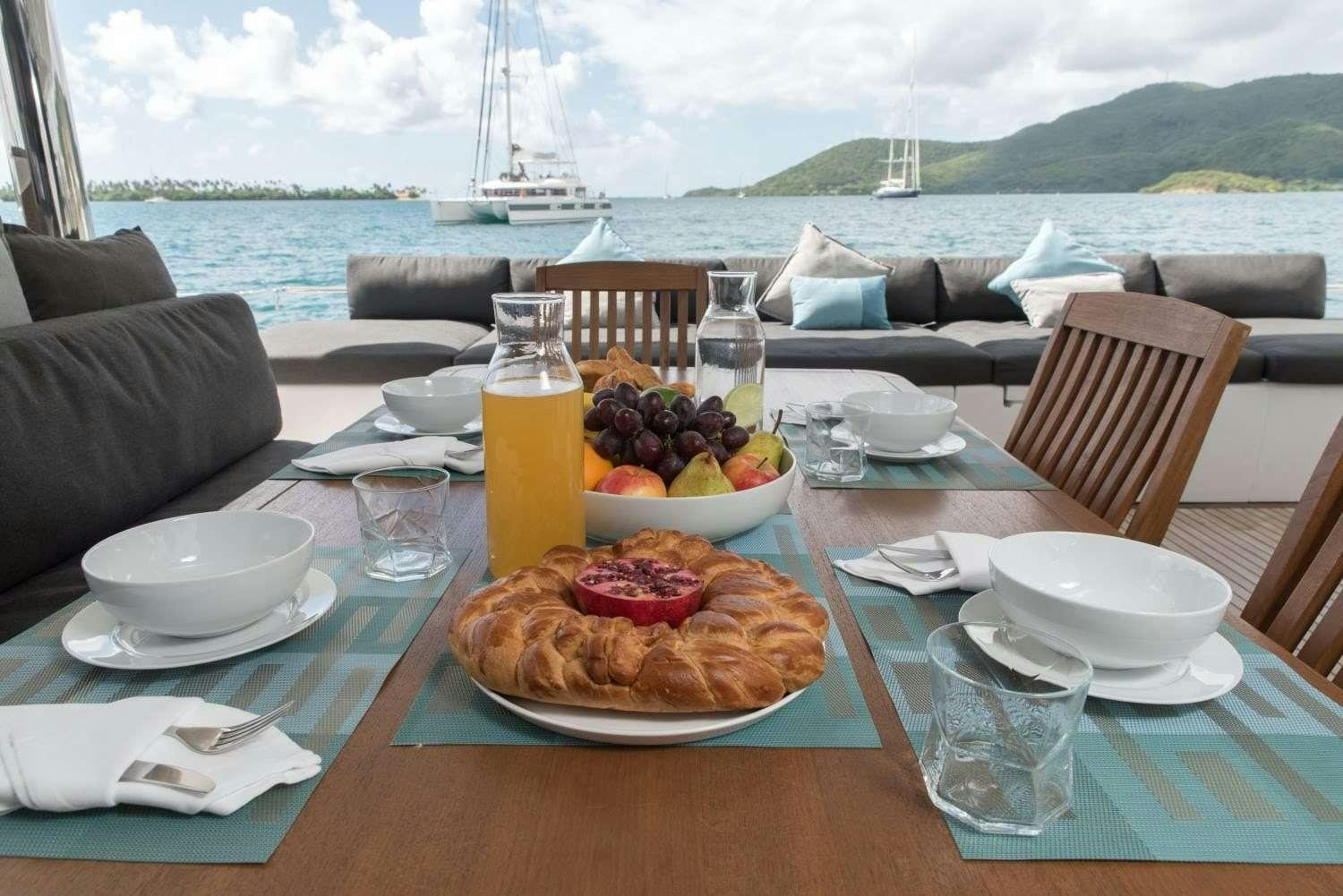 a table with food and drinks on it aboard MELARNIE Yacht for Charter