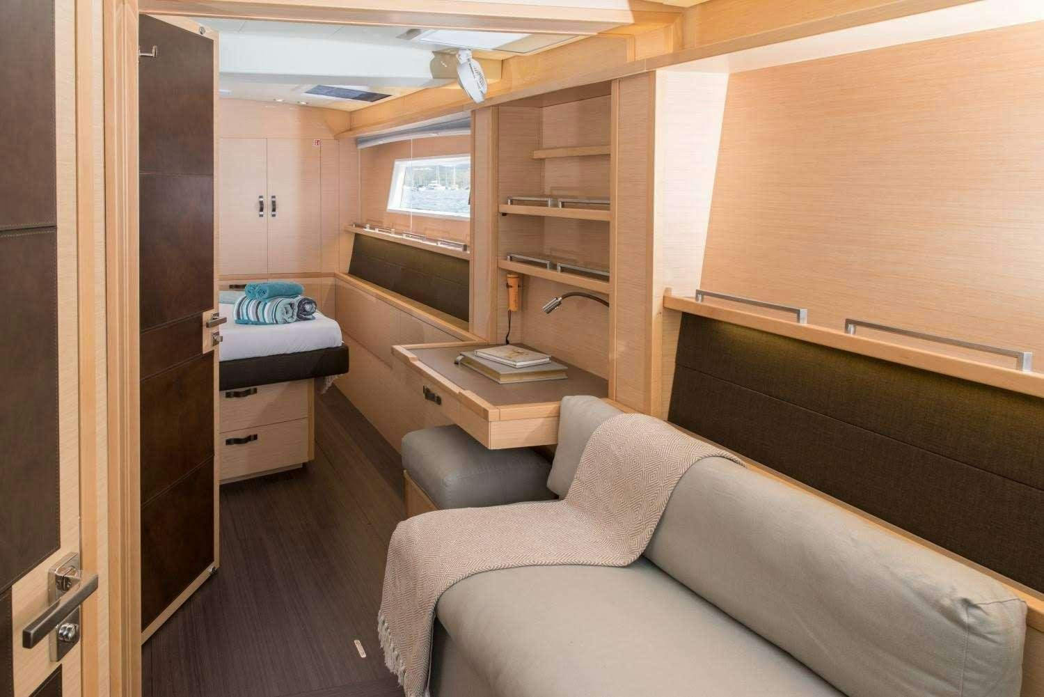 a room with a bed and a desk aboard MELARNIE Yacht for Charter