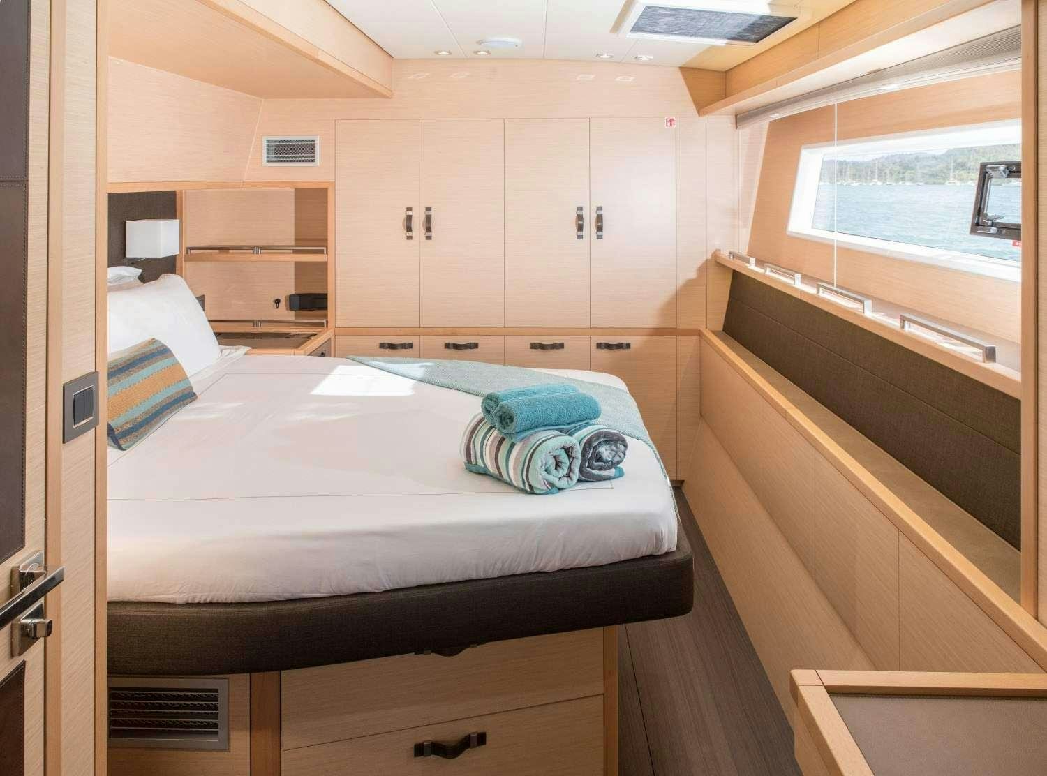 a room with a bed and cabinets aboard MELARNIE Yacht for Charter