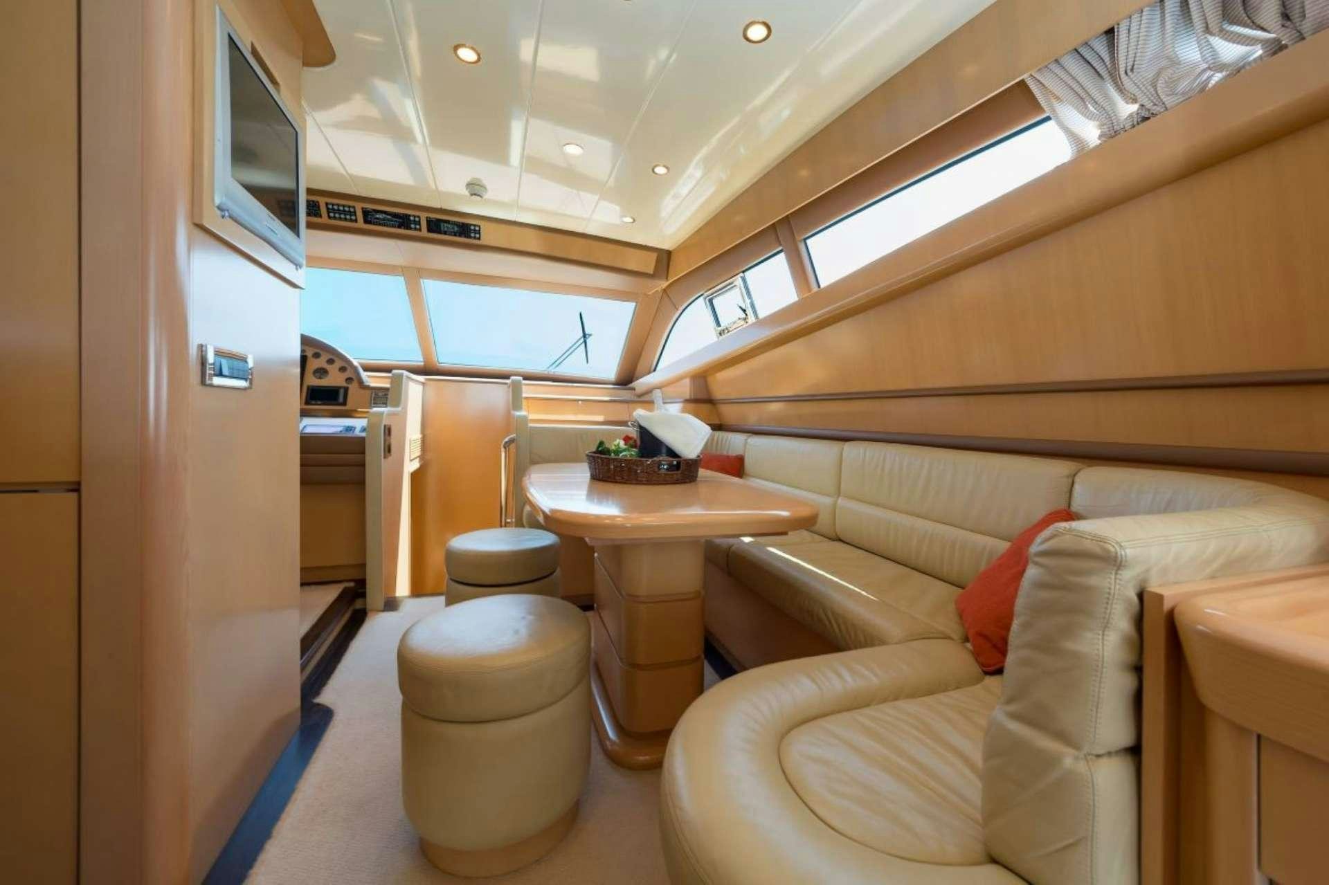 a room with a table and chairs aboard LETTOULI III Yacht for Charter