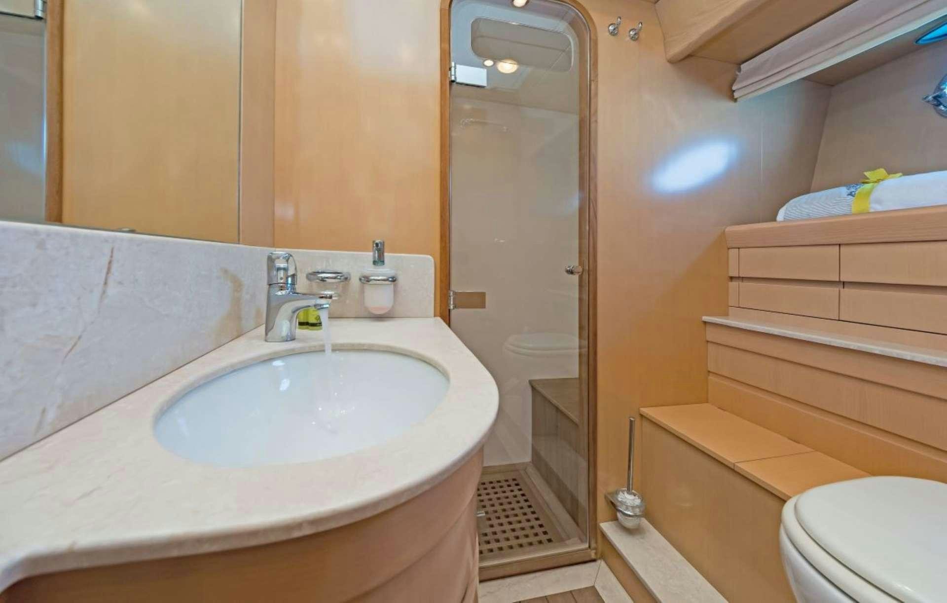 a bathroom with a sink and a toilet aboard LETTOULI III Yacht for Charter