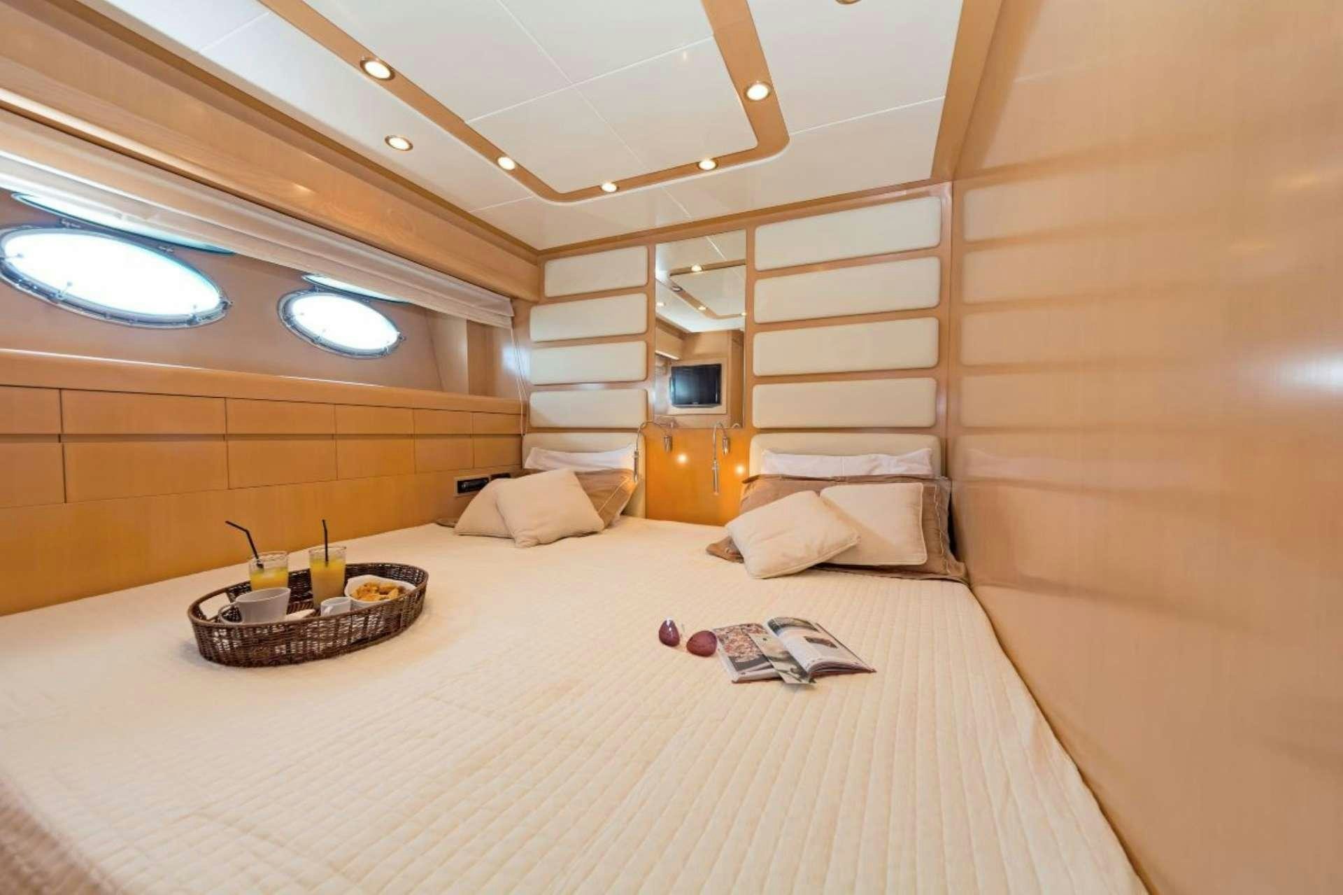 a large bed with a white bed aboard LETTOULI III Yacht for Charter