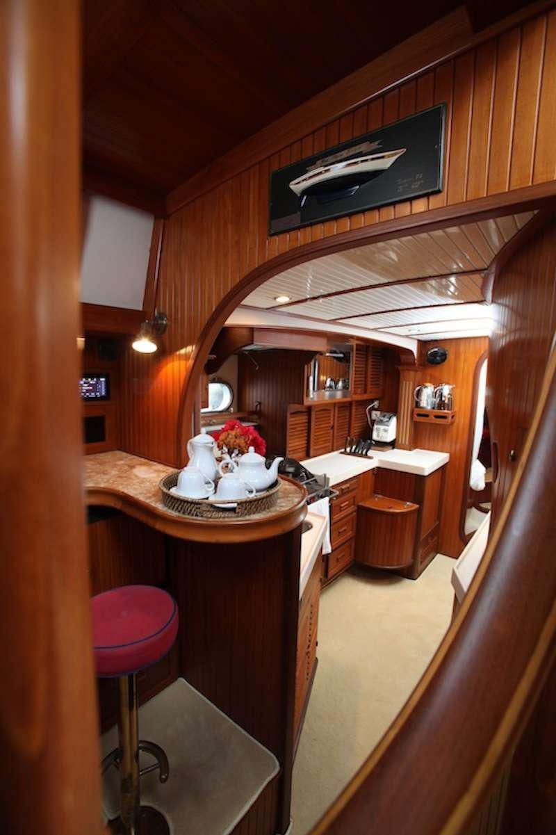a kitchen with a table and chairs aboard MORGANE Yacht for Charter