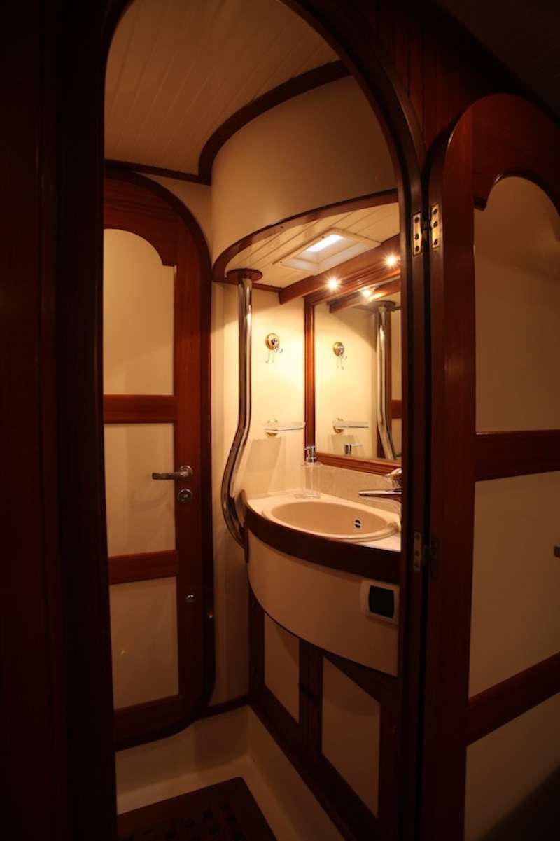 a bathroom with a sink and mirrors aboard MORGANE Yacht for Charter