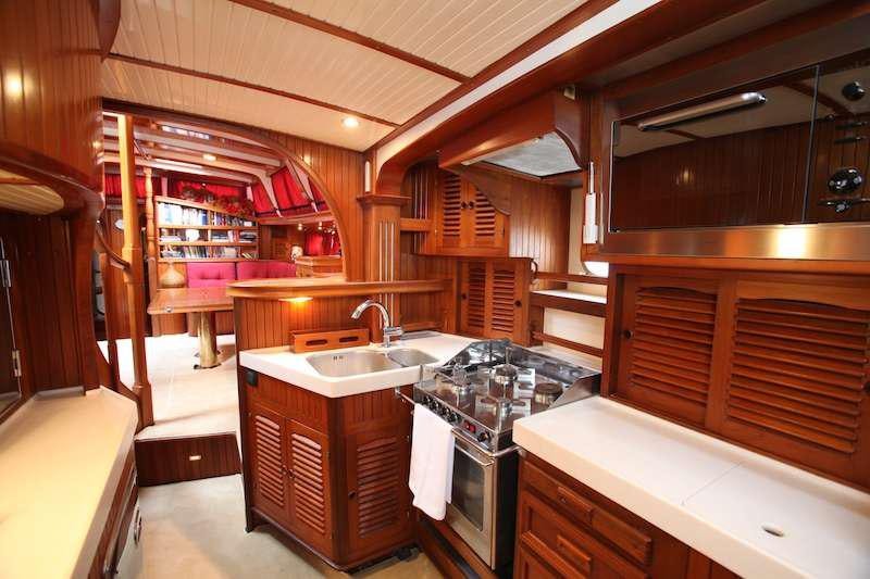a kitchen with wooden cabinets aboard MORGANE Yacht for Charter