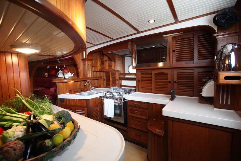 a kitchen with wooden cabinets aboard MORGANE Yacht for Charter
