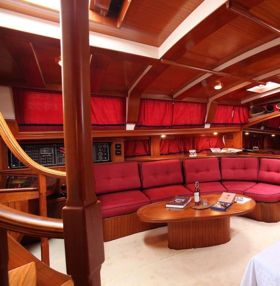 a room with a table and couches aboard MORGANE Yacht for Charter