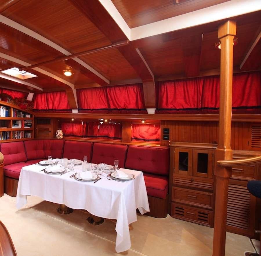 a dining room with a table and chairs aboard MORGANE Yacht for Charter