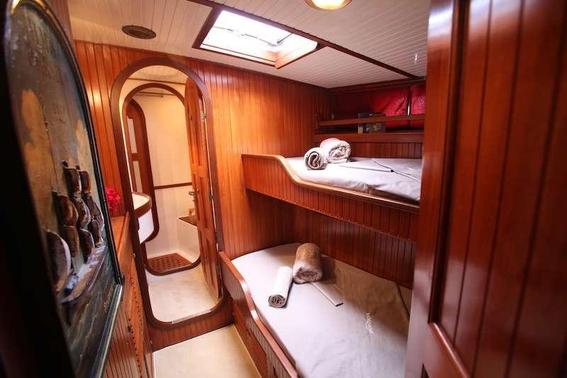 a room with a bed and a mirror aboard MORGANE Yacht for Charter