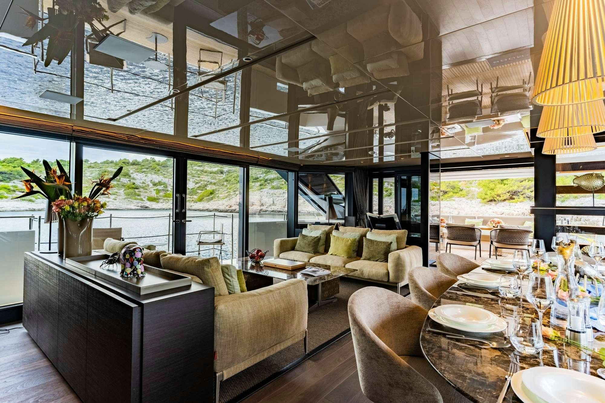 a room with a table chairs and a couch aboard NOOR II Yacht for Charter