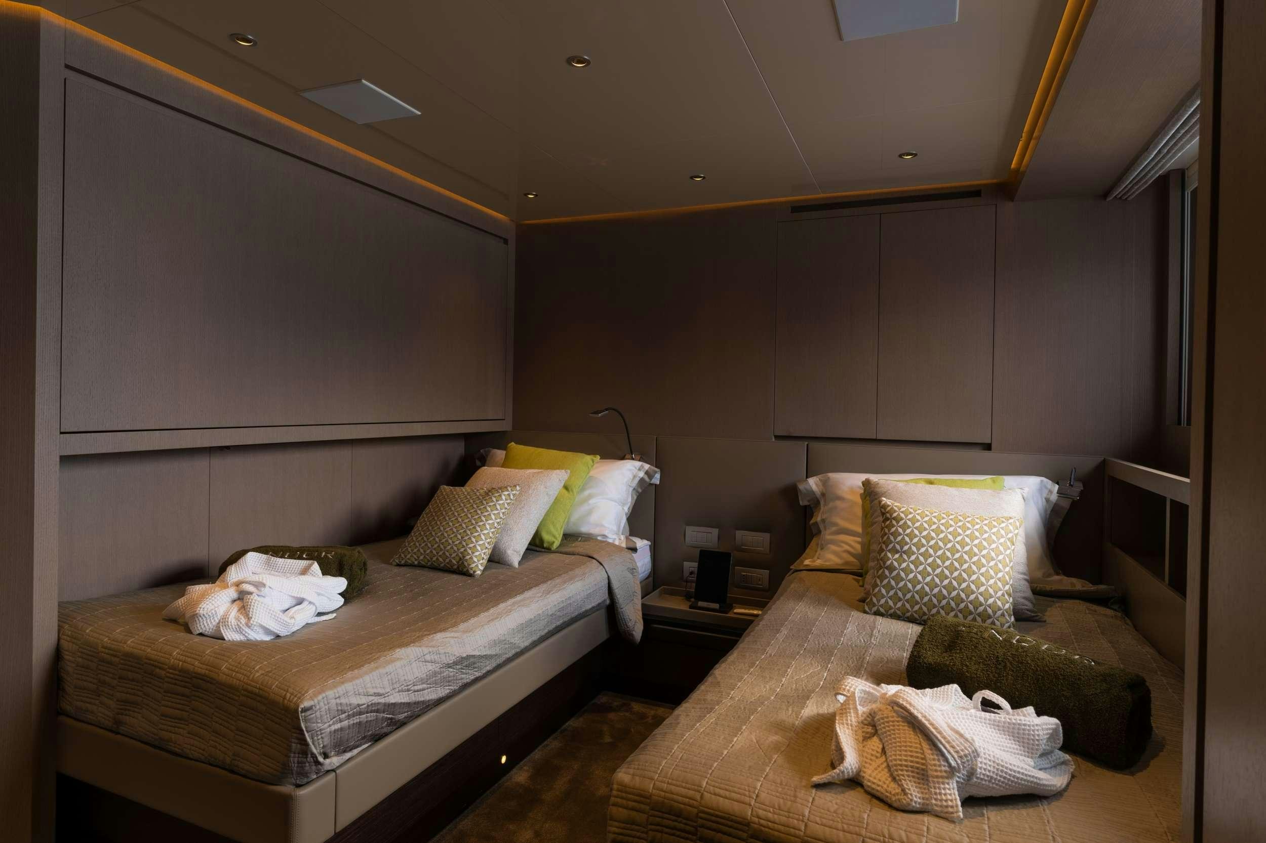 a couple of beds in a room aboard NOOR II Yacht for Charter