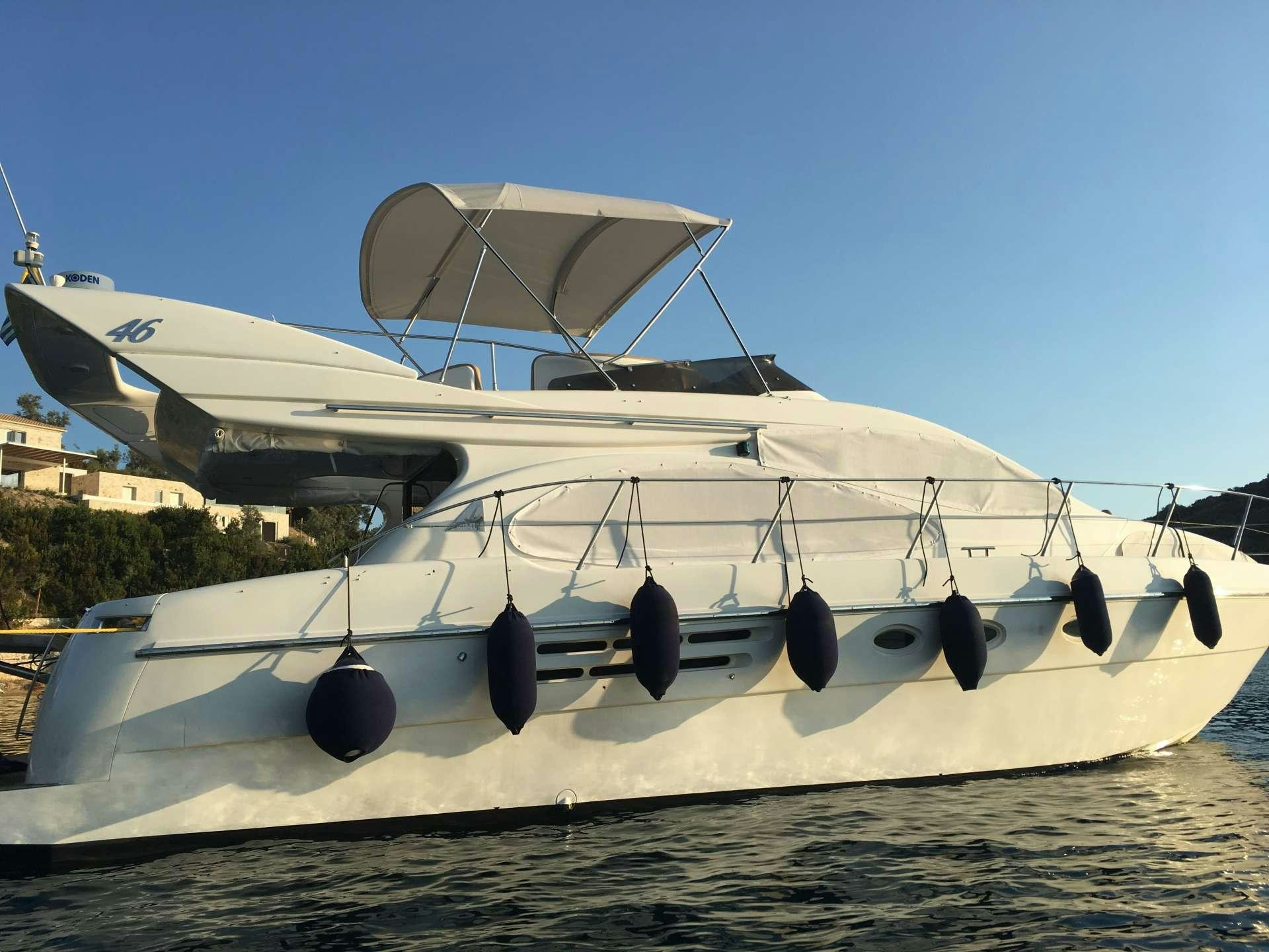 a white boat on a beach aboard ALMA LIBRE II Yacht for Charter
