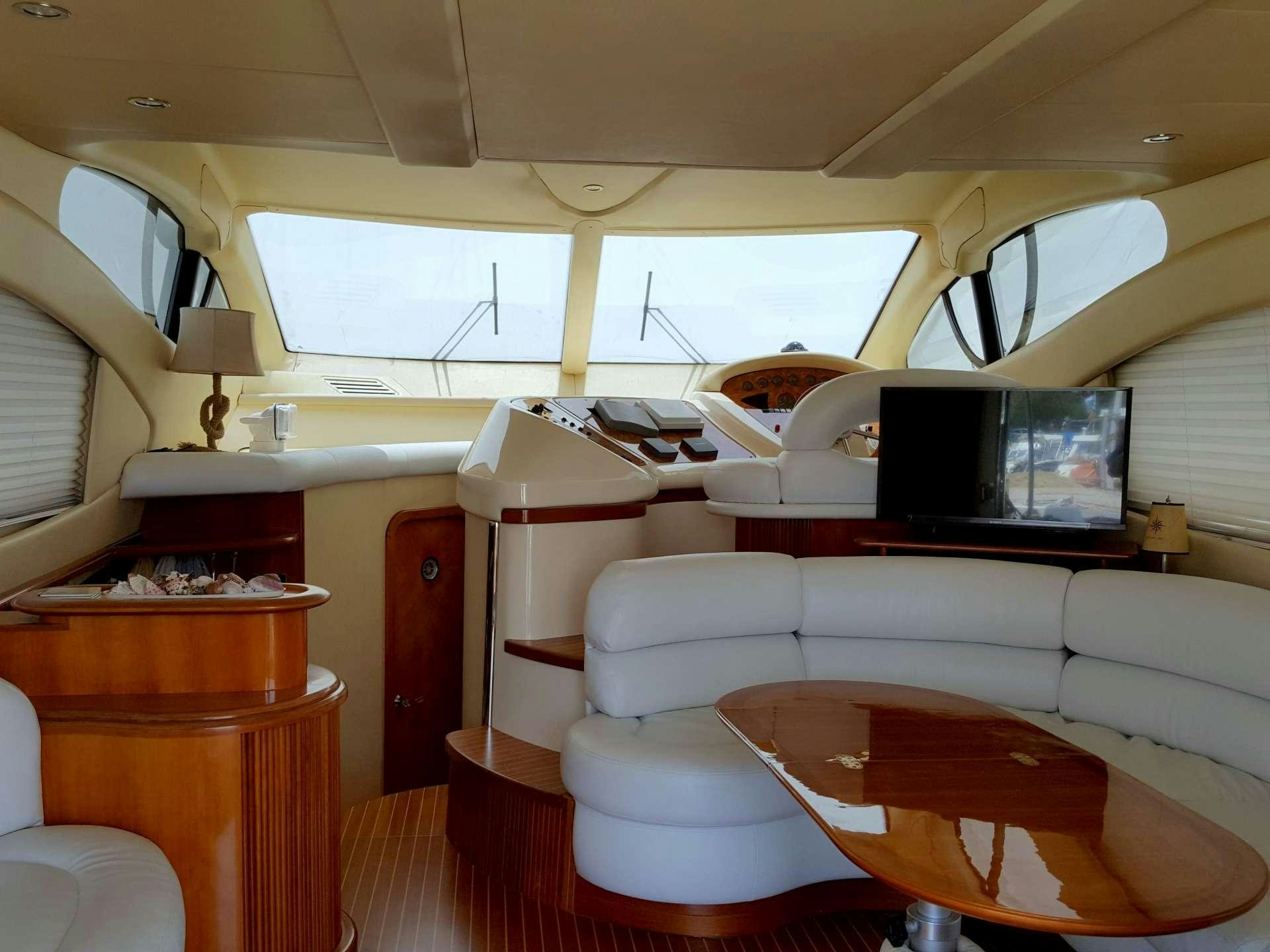 a living room with a couch and a television aboard ALMA LIBRE II Yacht for Charter