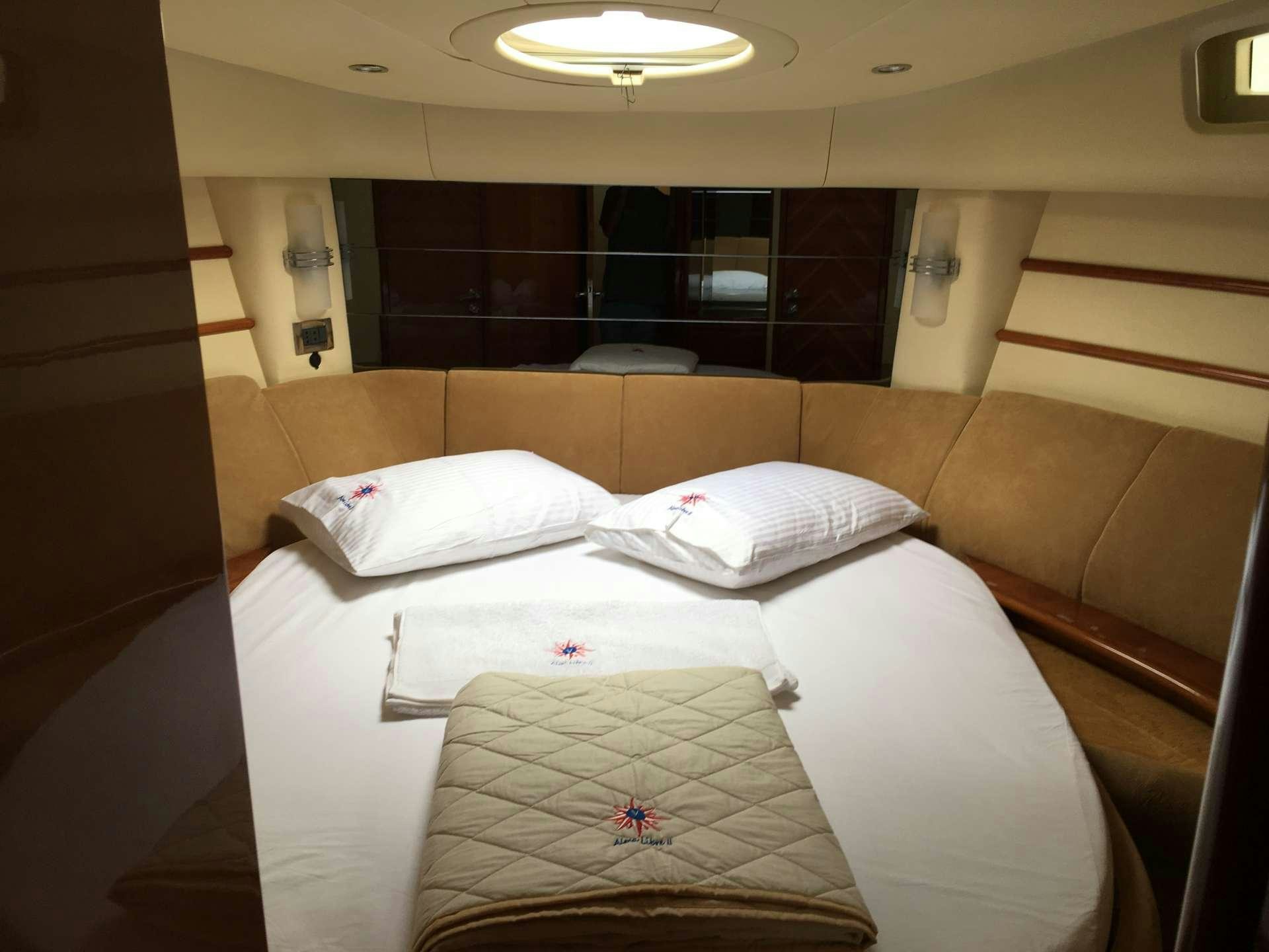 a couple of beds in a room aboard ALMA LIBRE II Yacht for Charter