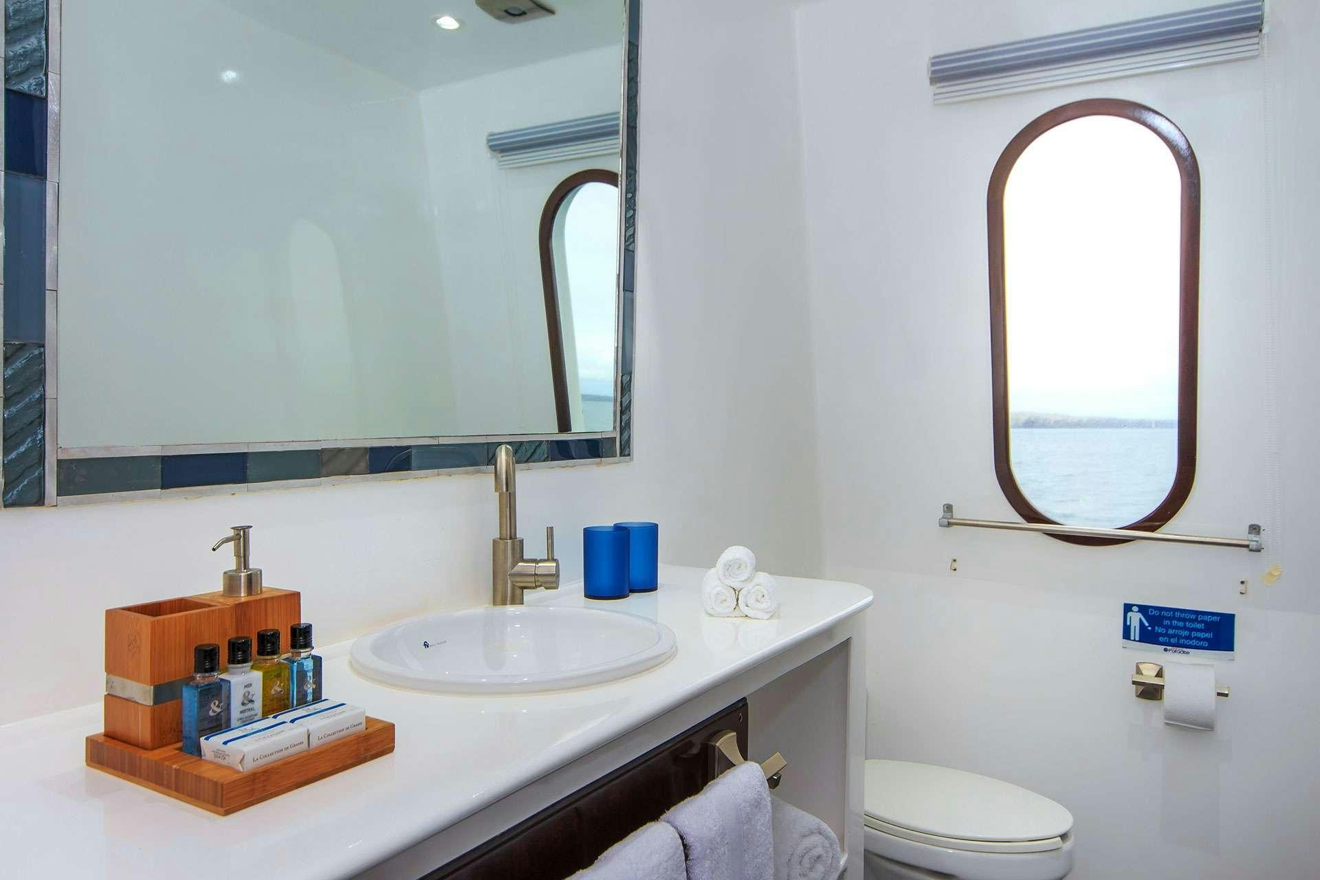 a bathroom with a mirror and a sink aboard NATURAL PARADISE Yacht for Charter