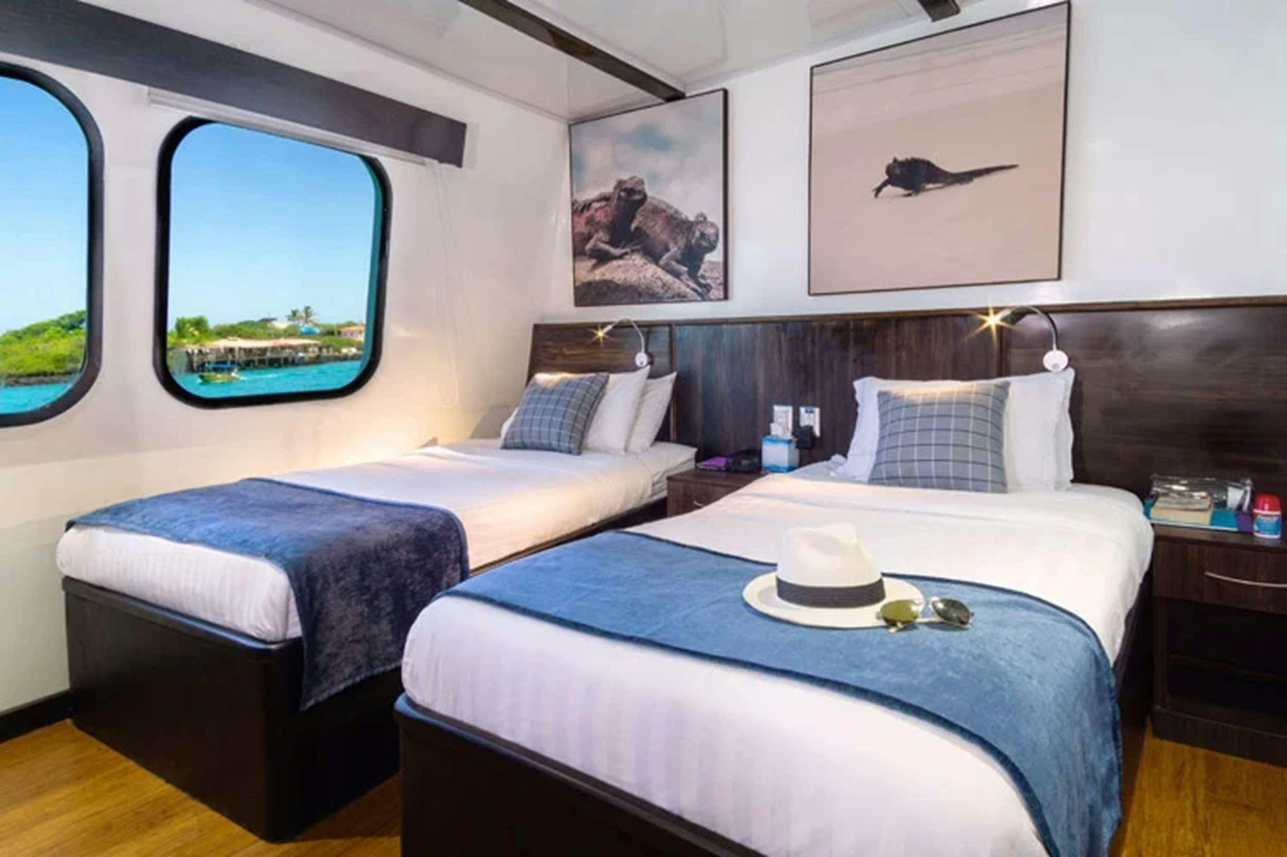 a couple of beds in a room aboard NATURAL PARADISE Yacht for Charter