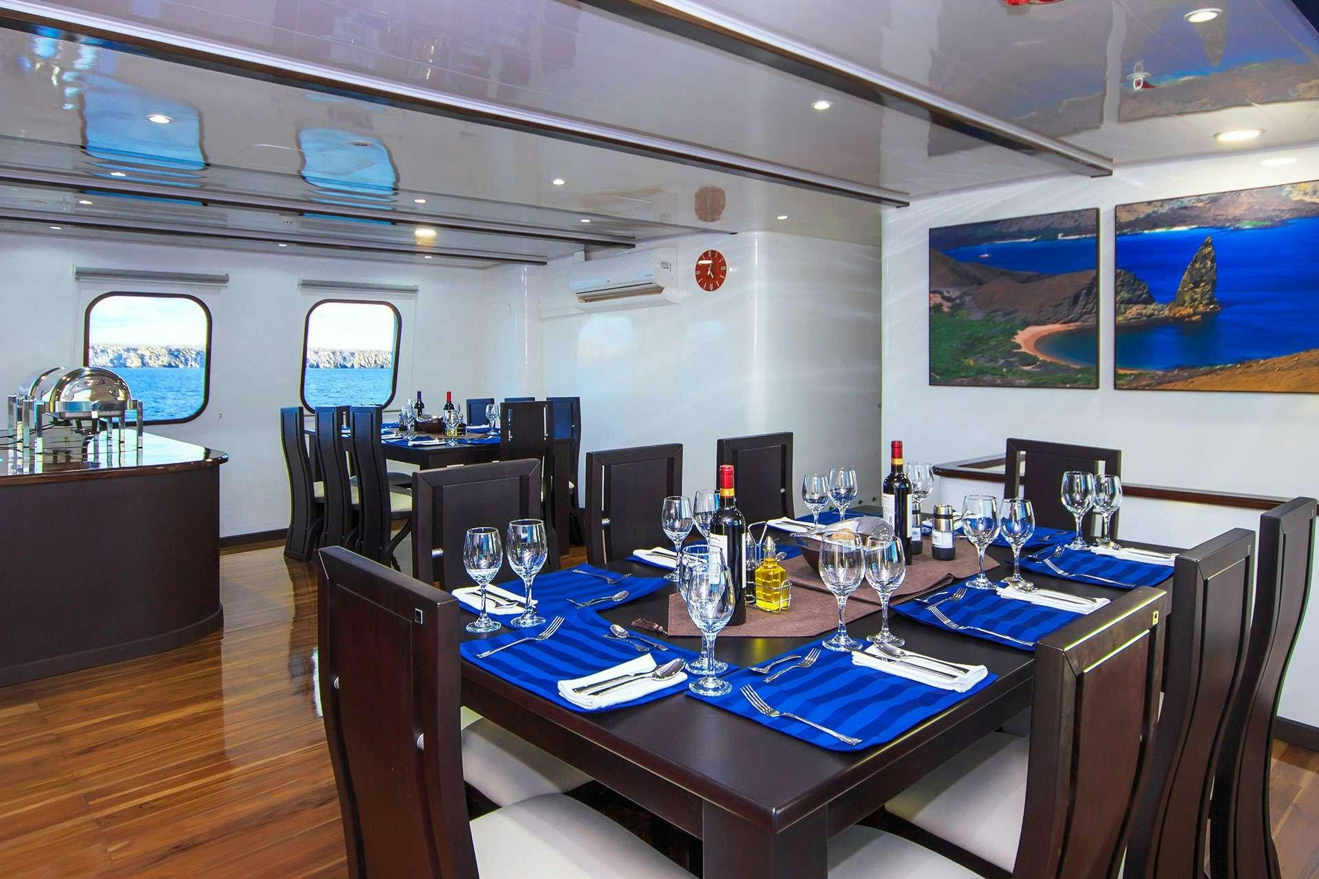 a table with wine glasses on it aboard NATURAL PARADISE Yacht for Charter
