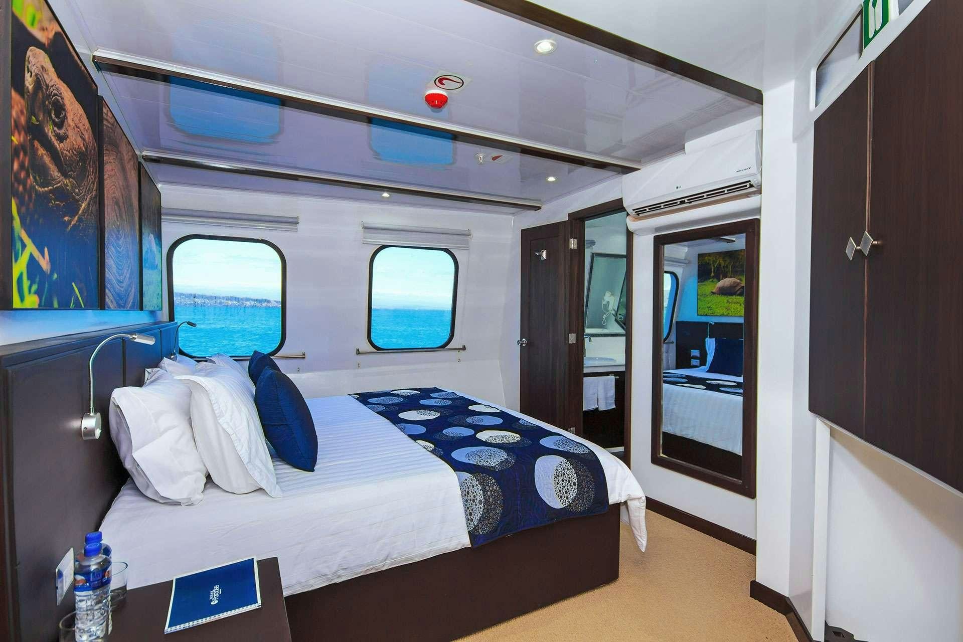 a room with a bed and a window aboard NATURAL PARADISE Yacht for Charter
