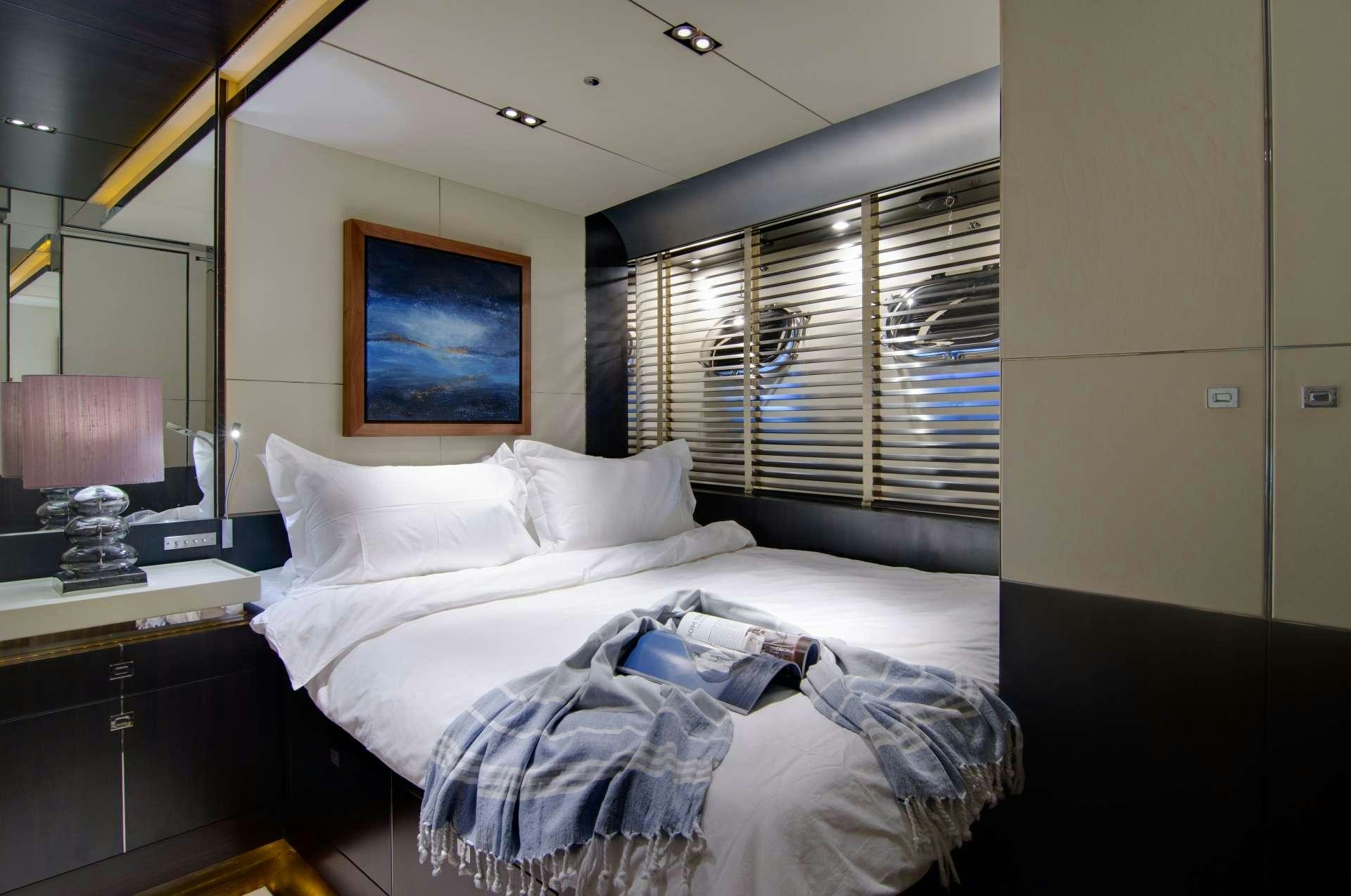 a couple of beds in a hotel room aboard MAC Yacht for Charter