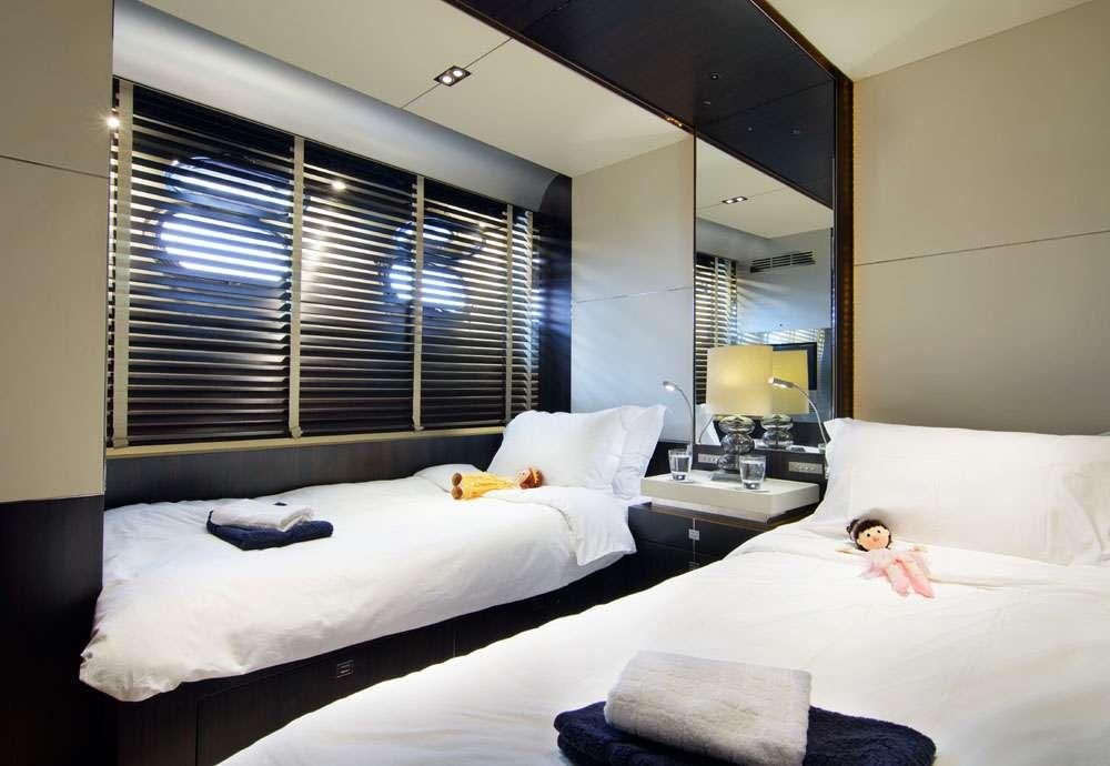 a couple of beds in a hotel room aboard MAC Yacht for Charter