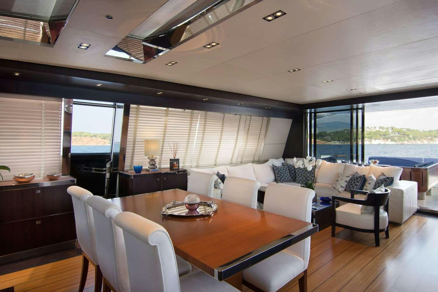 a large living room with a large window aboard MAC Yacht for Charter