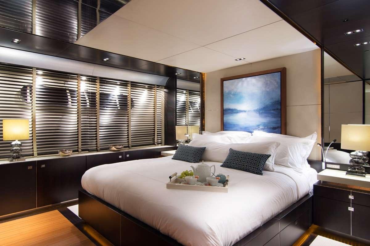 a bed with a white sheet and pillows aboard MAC Yacht for Charter