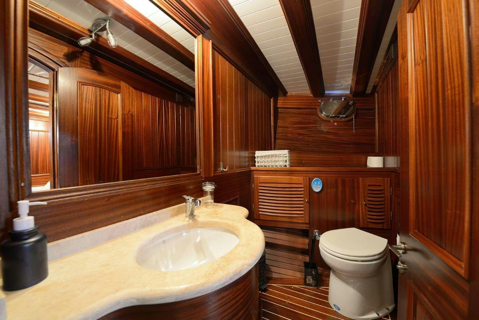 a bathroom with wooden walls aboard ZEPHYRIA II Yacht for Charter